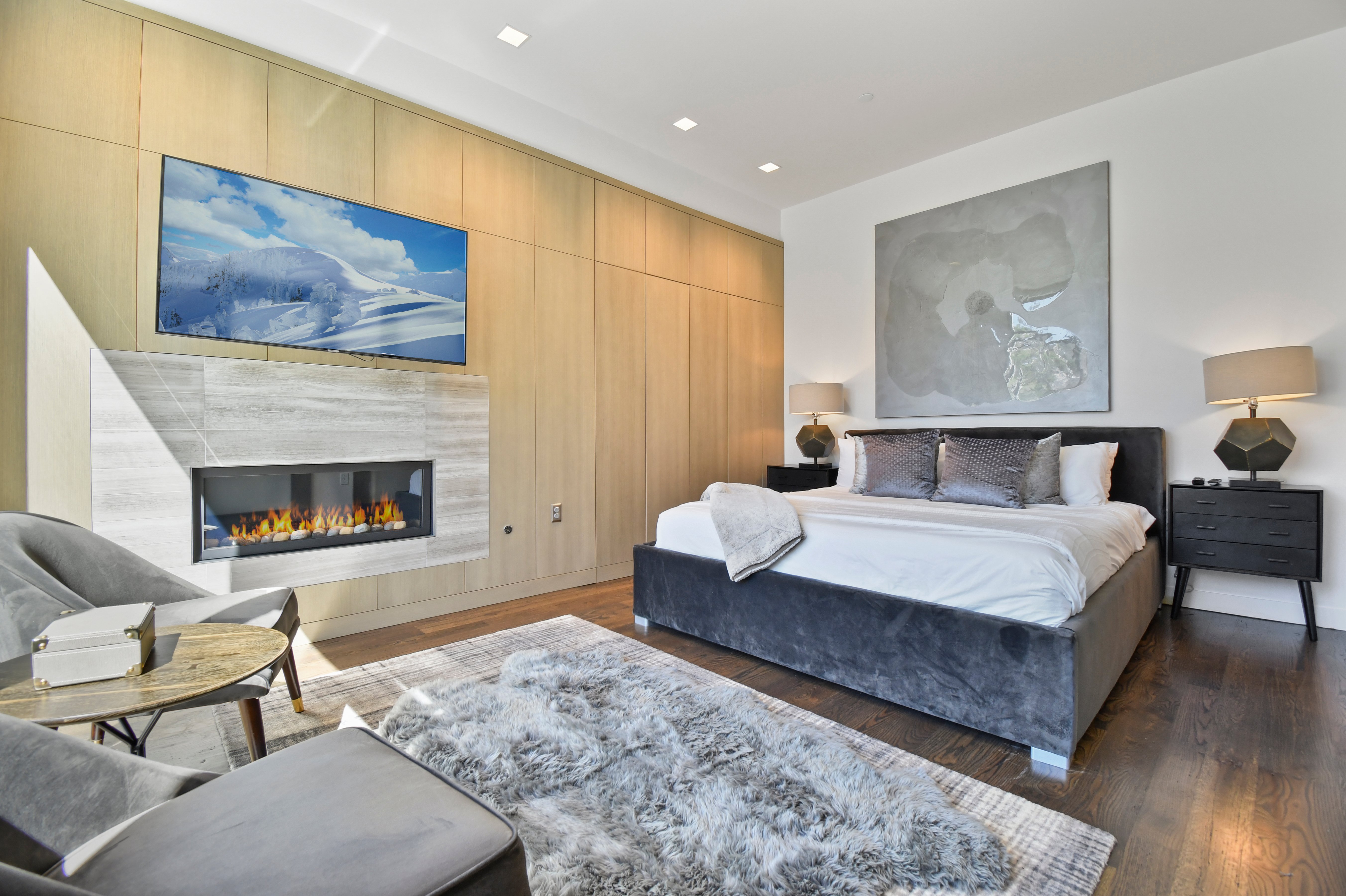 Master suite on the main level with a king bed and fireplace.