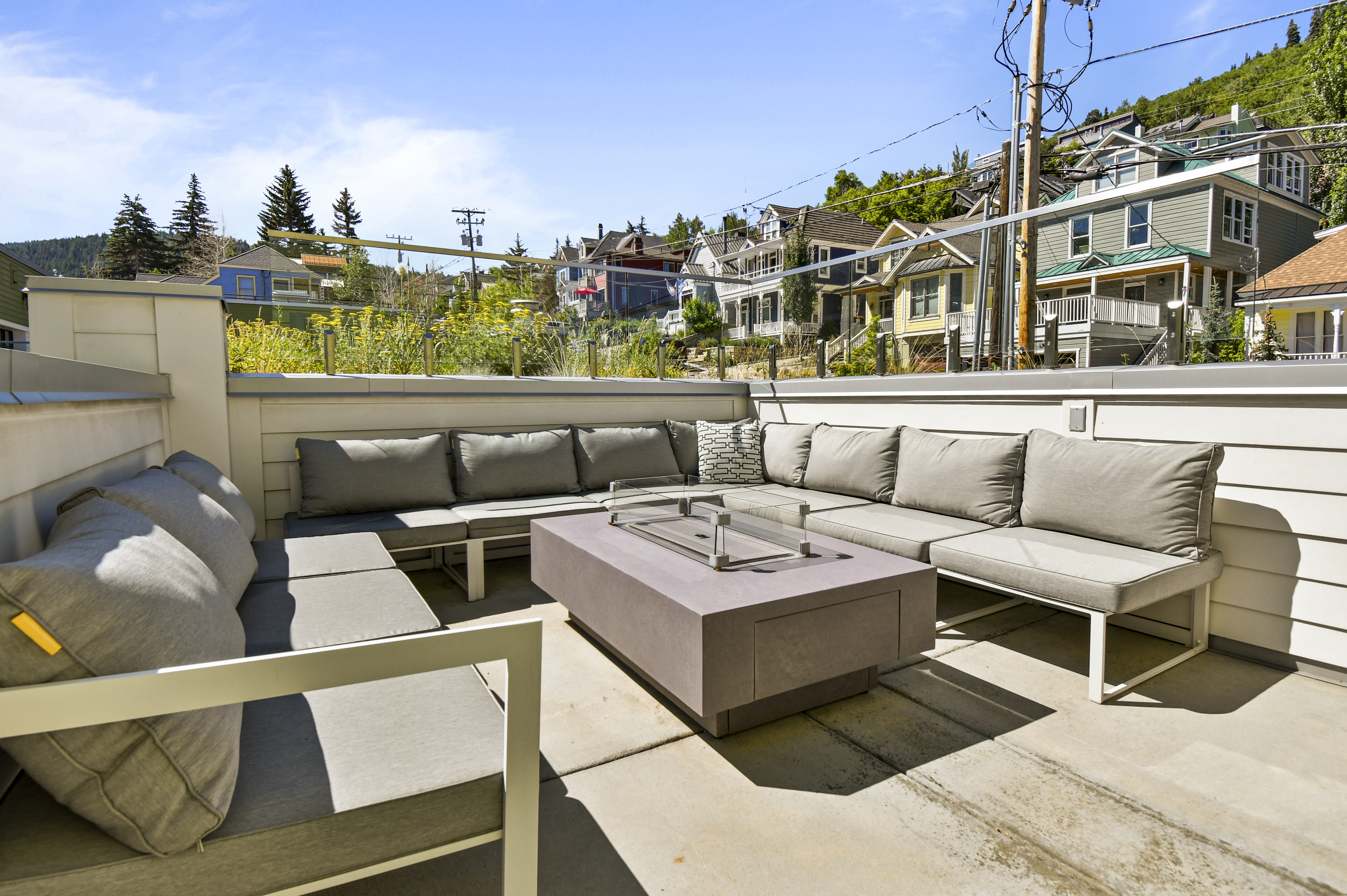 Comfortable seating surrounding your private fire pit on the balcony.
