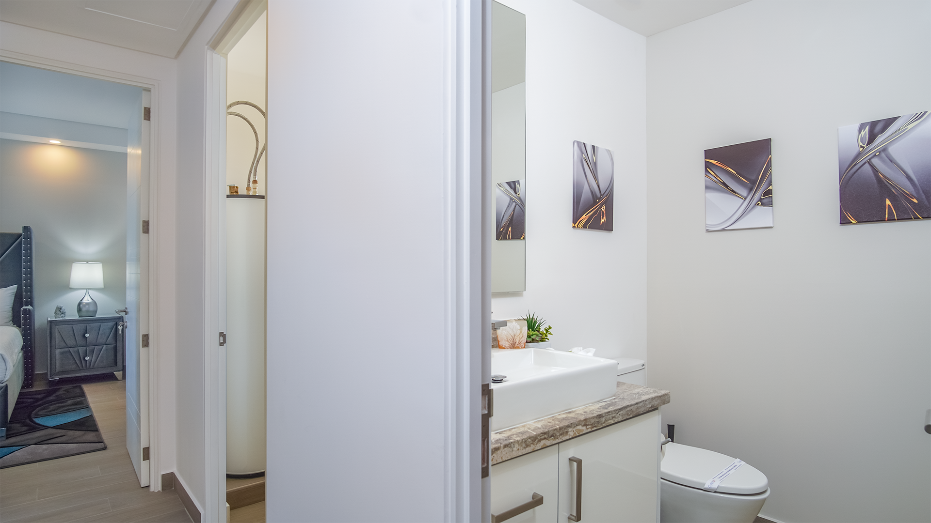 Off of the main hall you will find the guest bathroom, as well as a utility room.