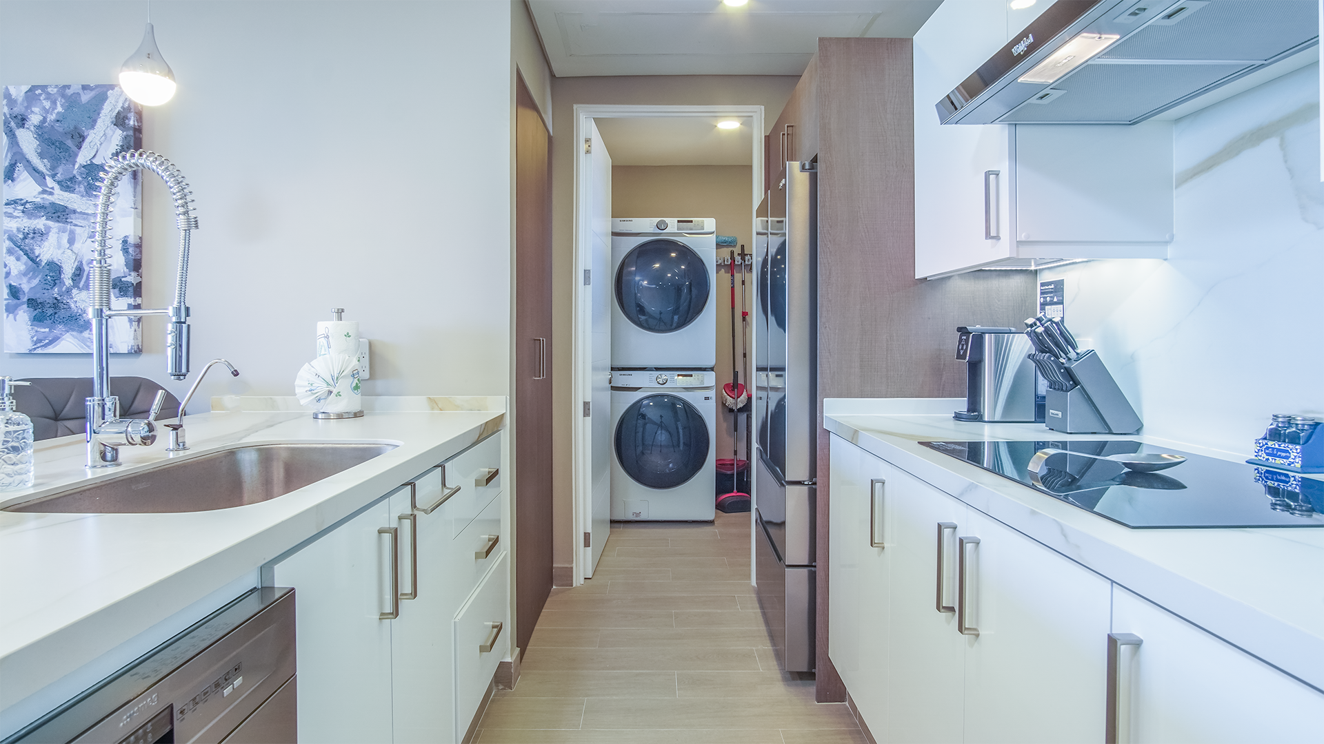 Walk through the kitchen to access the washer and dryer.