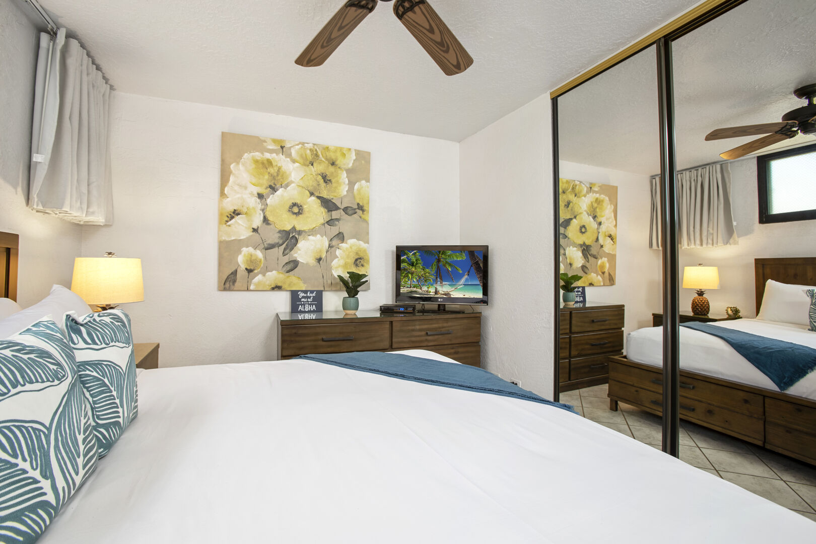 The bedroom features a king-size bed, ceiling fan, flat screen TV, nightstand, closet and dresser!