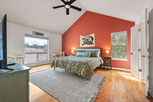 Master bedroom with a king bed and plenty of natural light