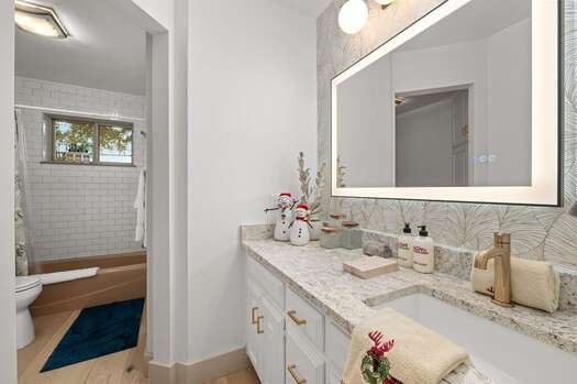 Shared bathroom 2 with a stone counter vanity and a separate tub/shower combo