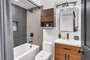 The guest bathroom is located in the hallway between the three guest bedrooms.  It has a shower/tub combo