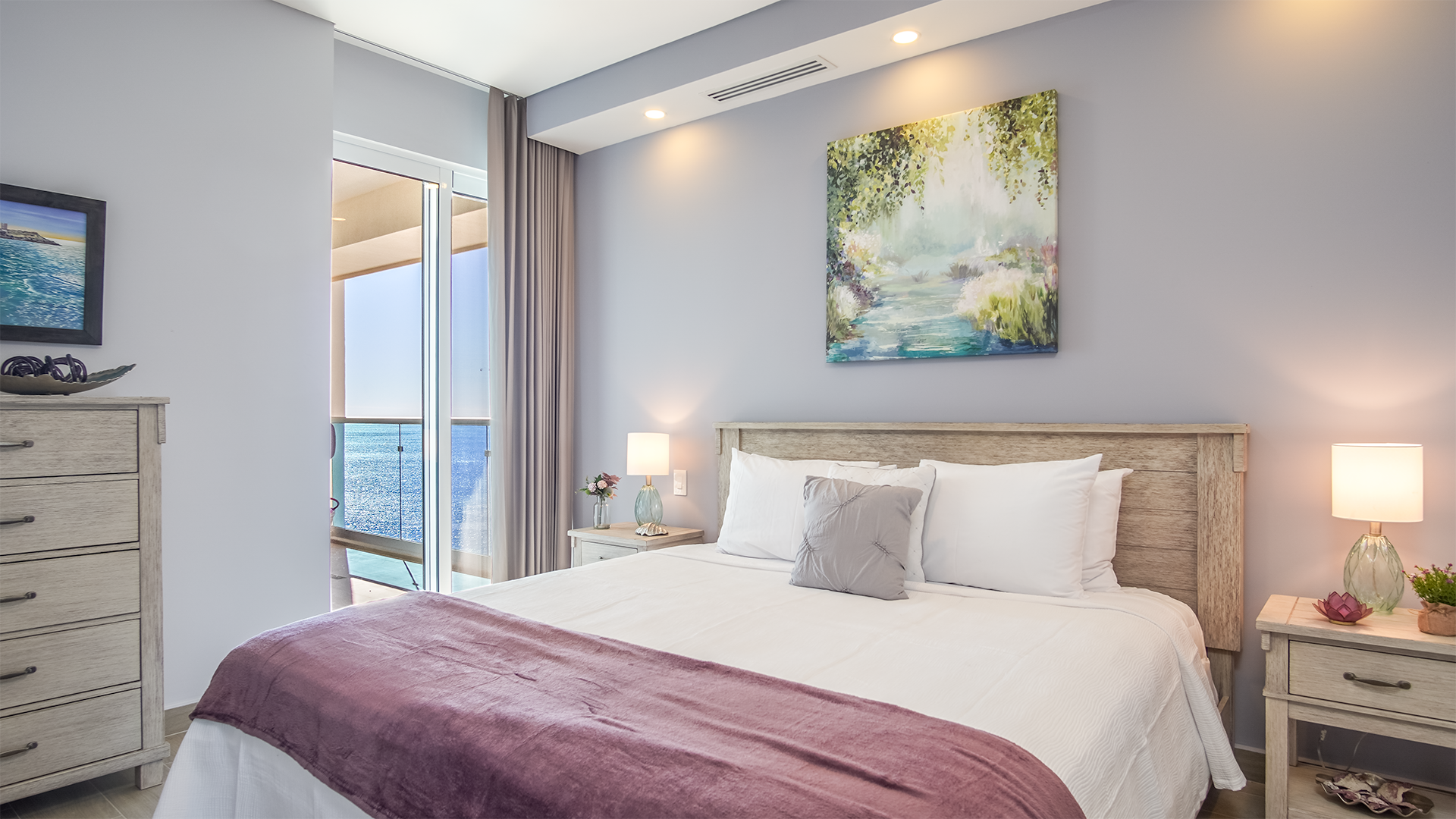 Second bedroom with king bed, and sliding glass doors that go out to the terrace with ocean views.