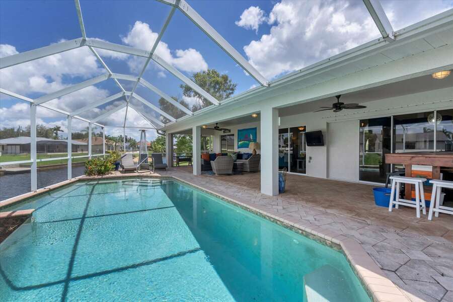 Pool area with tiki bar, loungers, lots of seating and 40