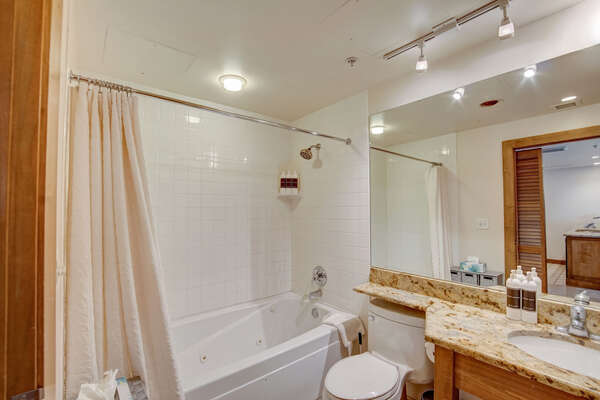 Bathroom with jetted bathtub and shower