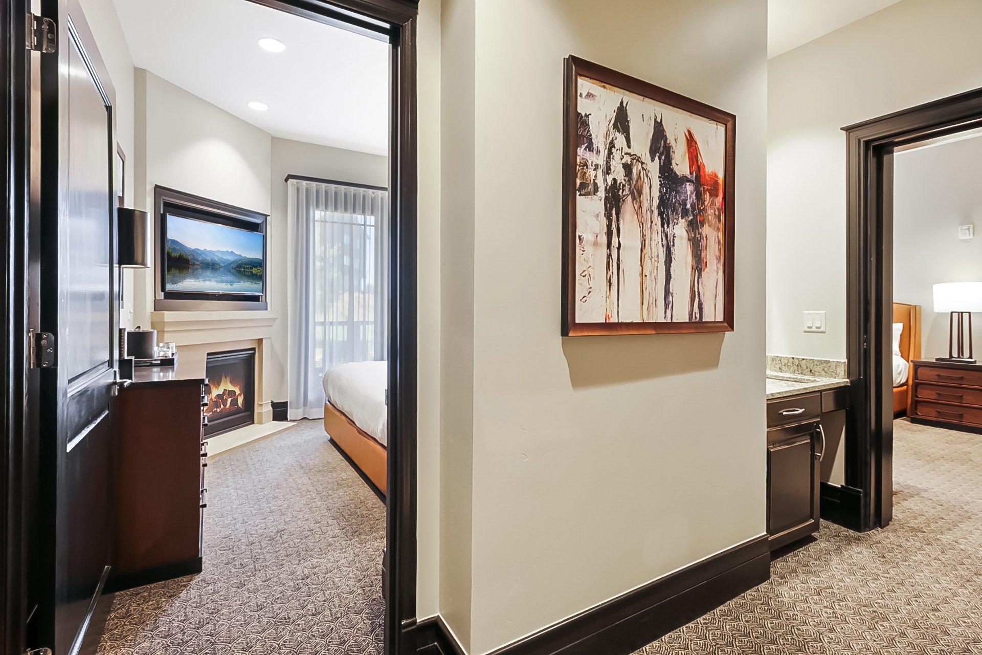 Walking from the grand unit, hallways to 2 guest room suites. Door to close for privacy as needed.