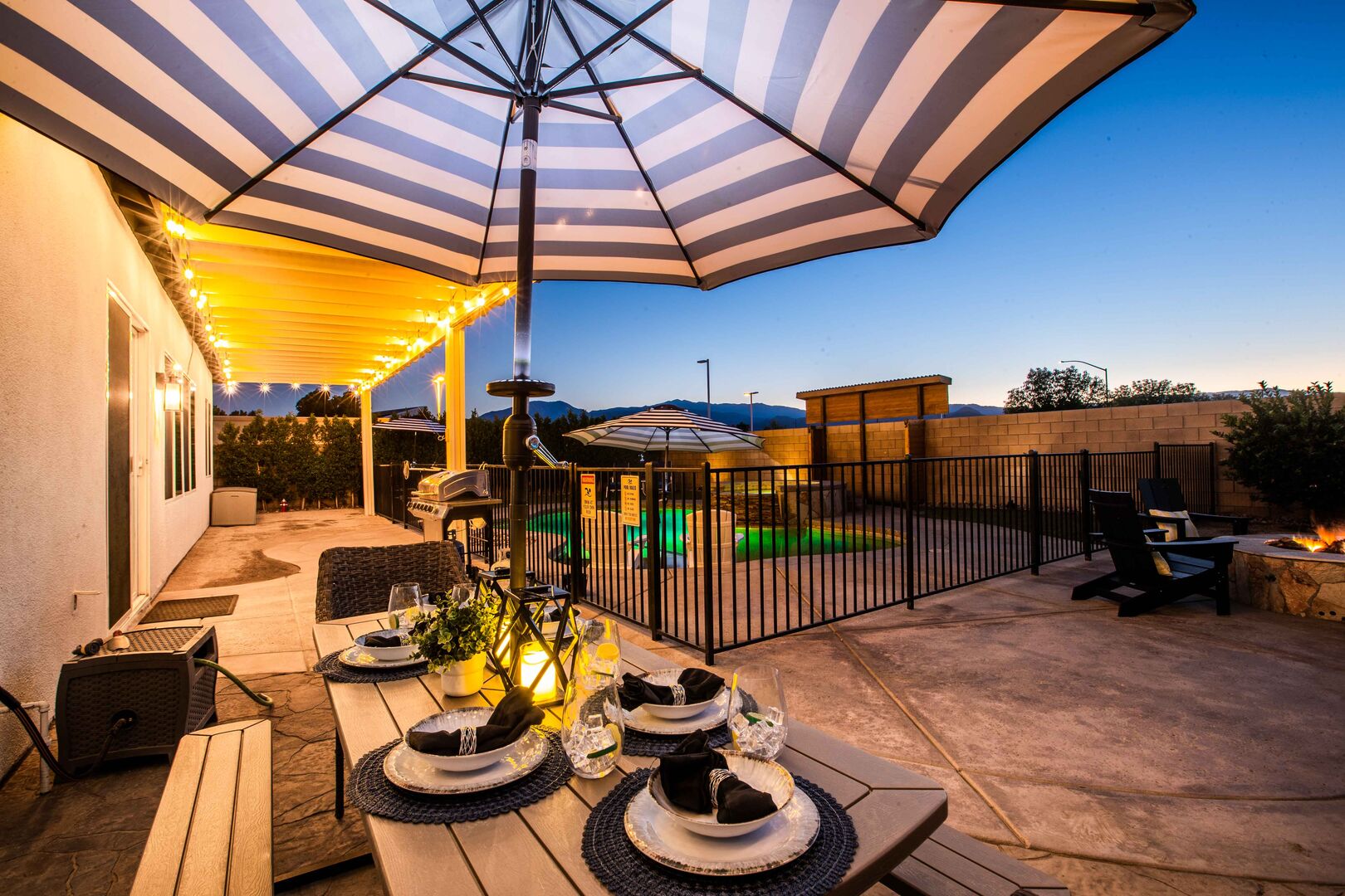 Savor delightful meals at the outdoor dining table, perfect for eight guests. Whether it's a sunny lunch or an enchanting evening dinner, you can use the umbrella for shade during the day and enjoy well-lit evening meals with a stunning view of the pool and sunset.