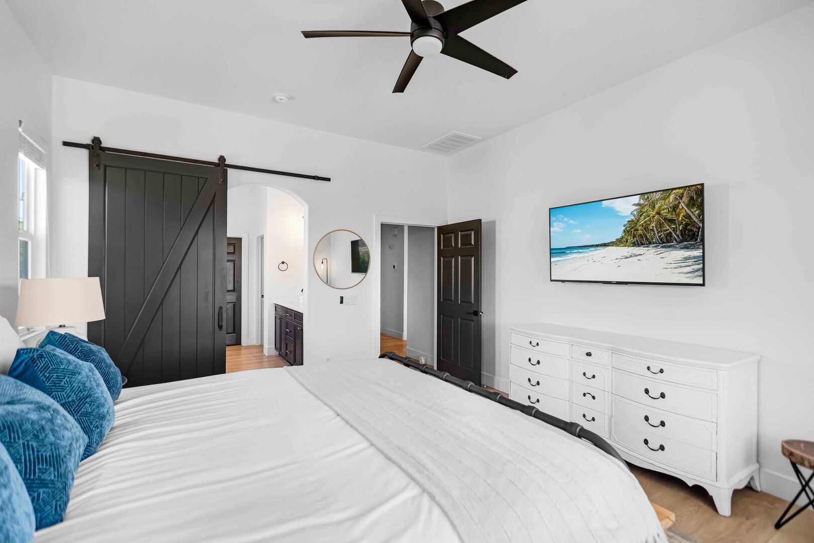 This bedroom boasts a sleek and elegant sliding barn door, giving you the option to keep it open for a spacious feel or close it for privacy— your choice.