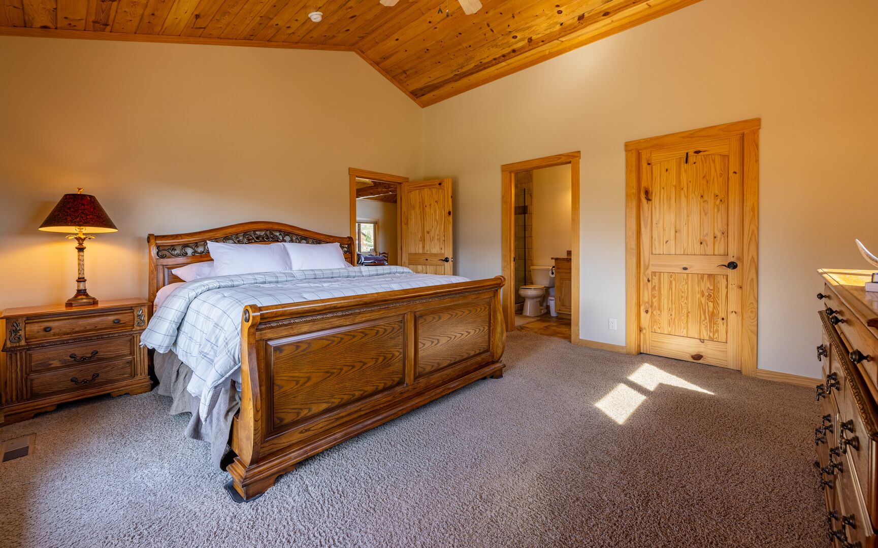Main bedroom suite with king bed and attached bathroom