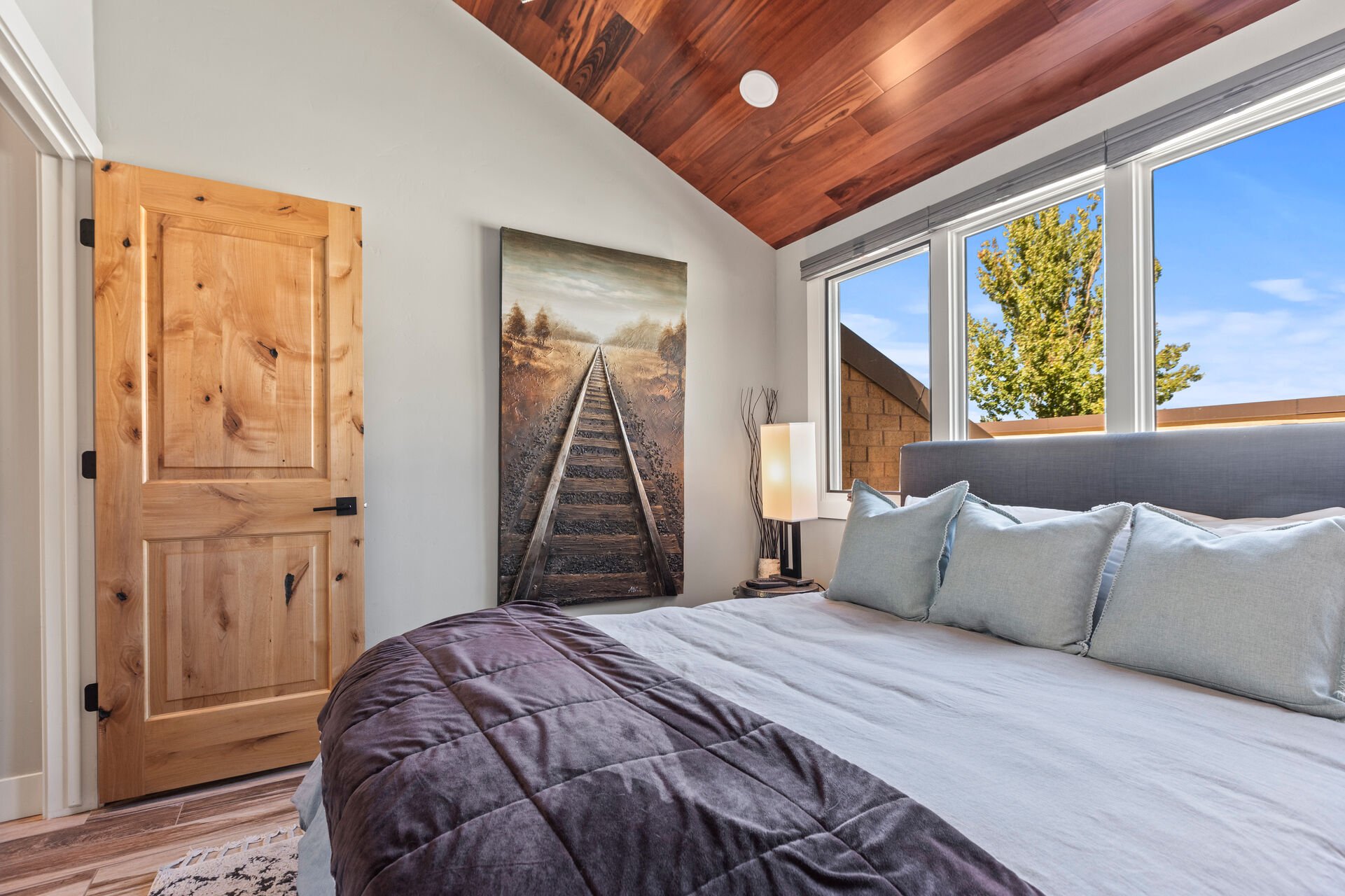 master bedroom 2 with a queen bed and plenty of natural light