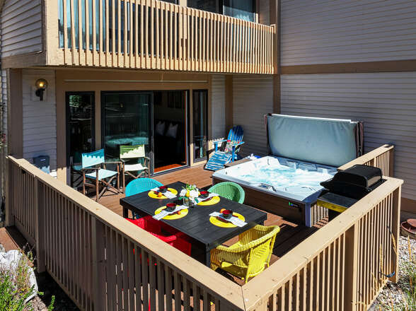 Spacious deck with patio seating, outdoor dining and soothing hot tub