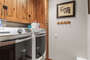 Full size washer and dryer with laundry soap and dryer sheets provided for guests.