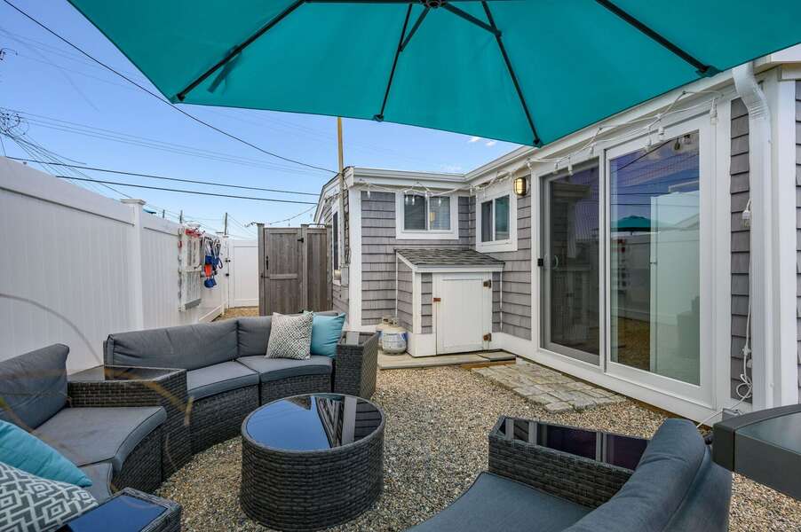 Back outdoor seating area with large umbrella, grill & outdoor shower- 217 Old Wharf Road #1A Dennis Port Cape Cod - Grey Pearl-NEVR