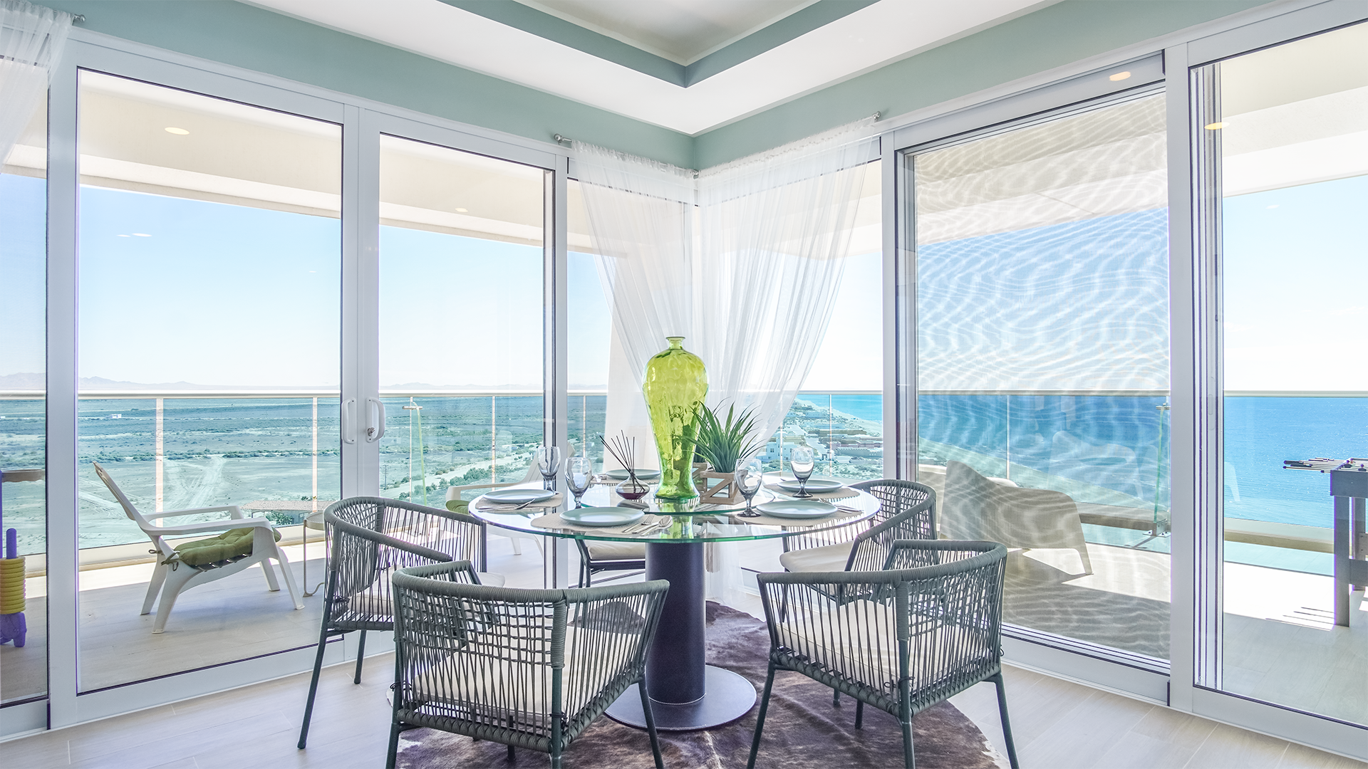Where all of the windows come together, the glass dining table commands excellent views.