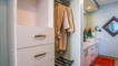 In the walk in closet you will find an abundance of drawers, nooks, hangers and more.