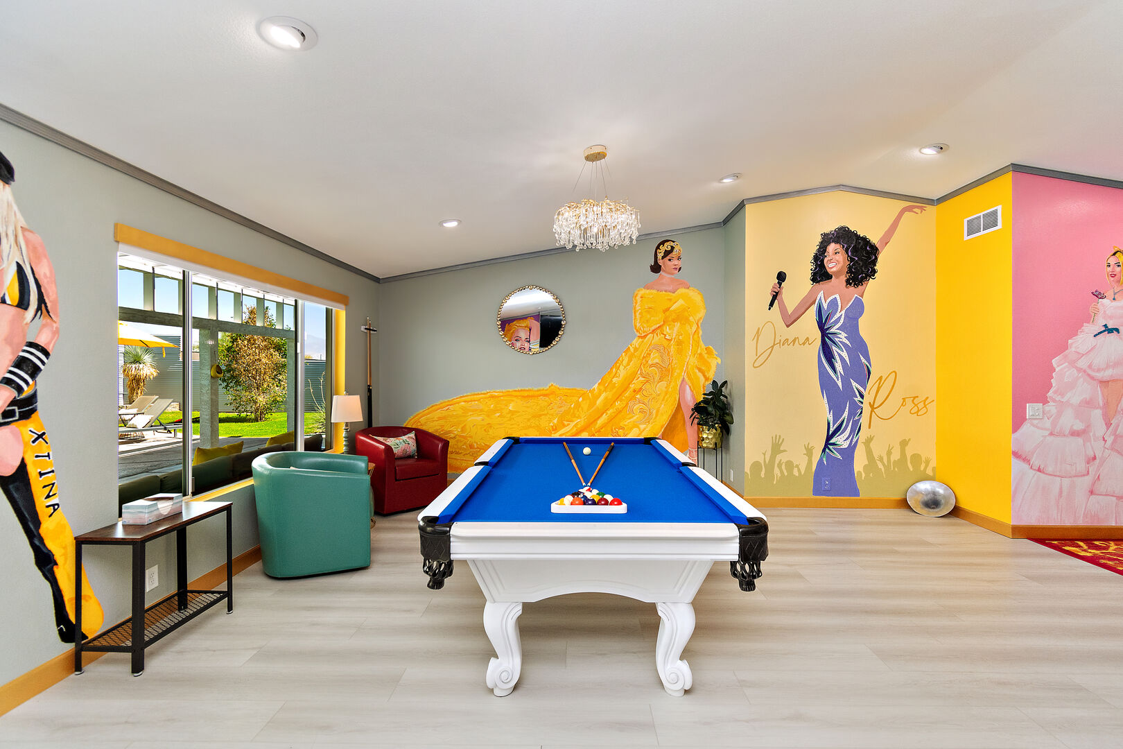 The pool table is conveniently placed next to amazing murals featuring Christina Aguilera, Rihanna, and Diana Ross.