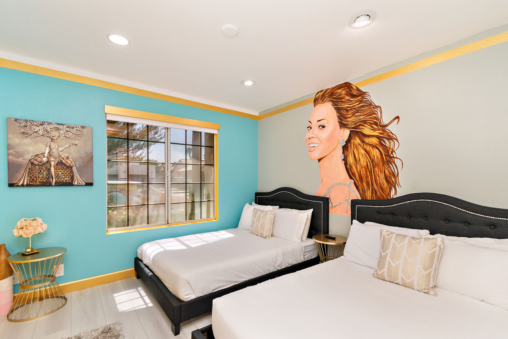 Bedroom 4 is located next to bedroom 3 and features two Full-sized Beds, a 40-inch TCL with Roku Smart television, and a Beyoncé mural.