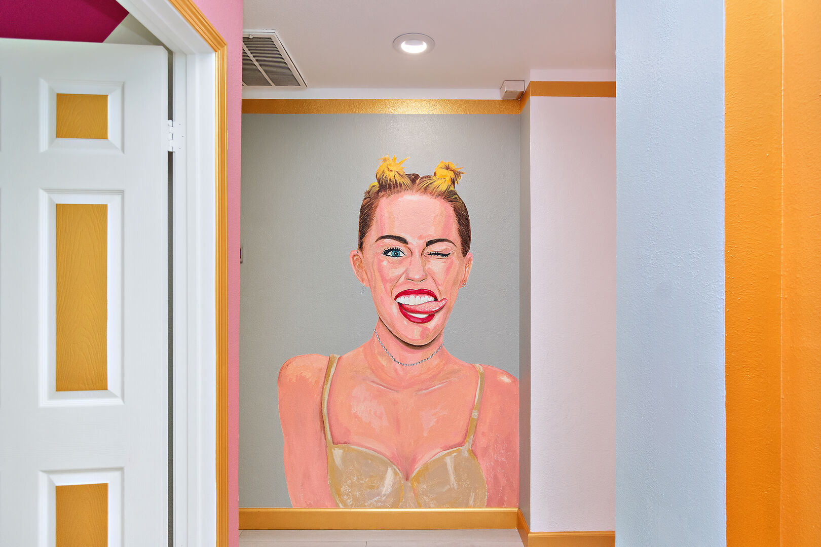 A delightful Miley Cyrus mural greets you as you stroll down the hallway.