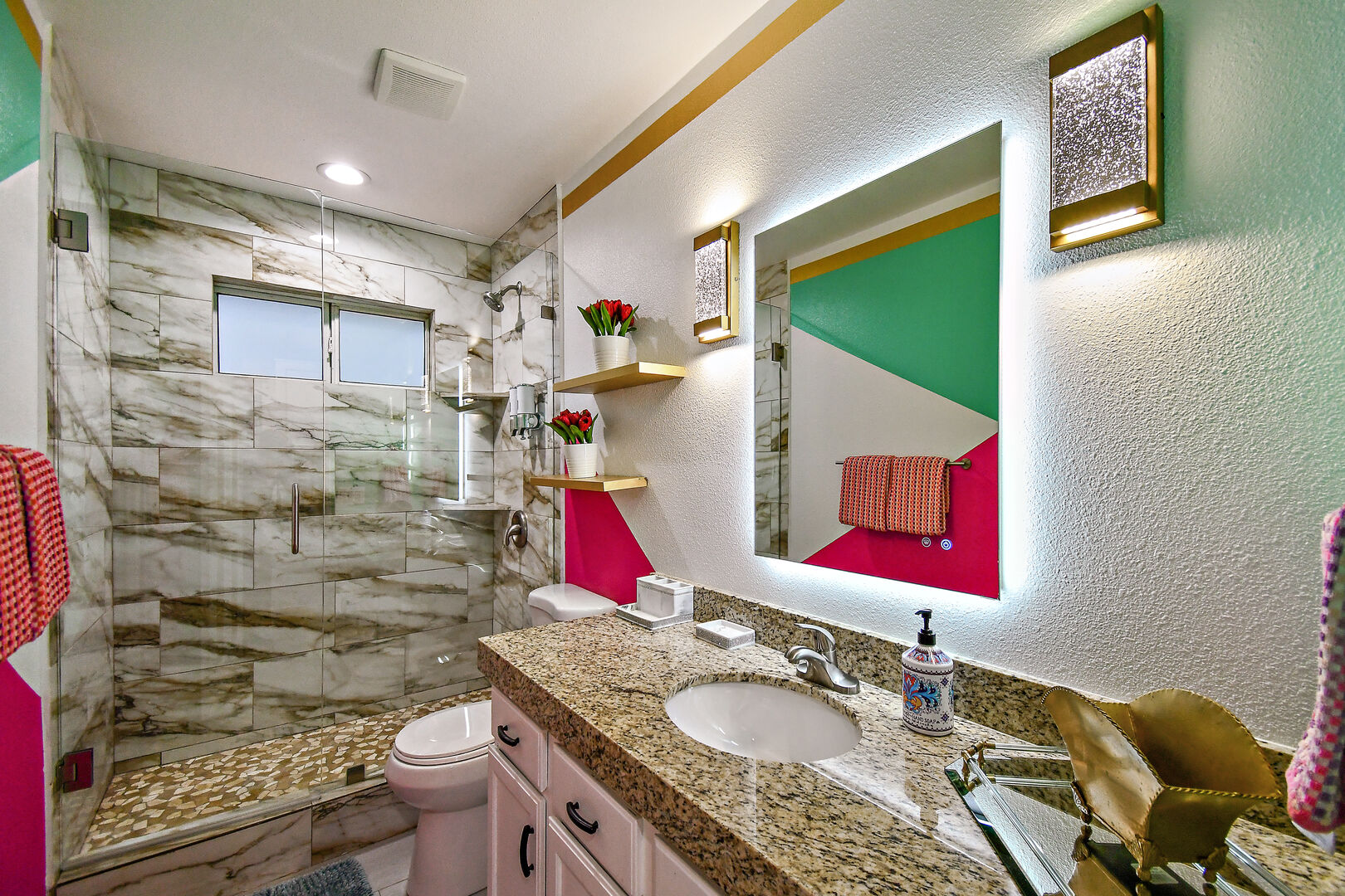 Hallway bathroom 2 is located next to bedroom 2 and features a tile shower and a vanity sink.