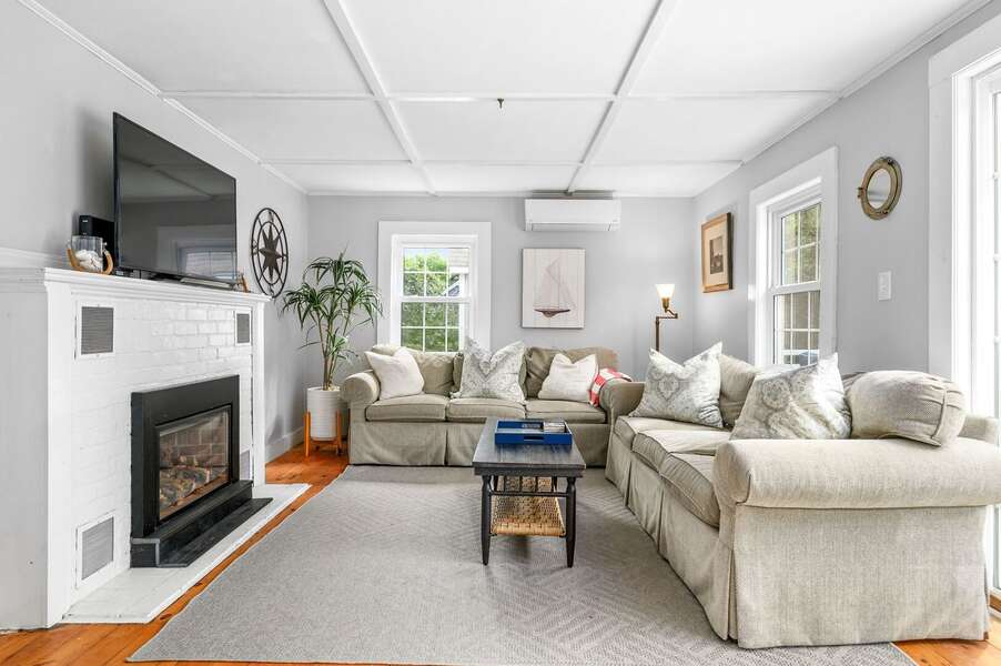Living area with an abundance of comfortable seating and gas fireplace- 135 Pine Knoll Avenue Chatham Cape Cod - Sarah-N-Dipity - NEVR