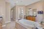 Primary bathroom with double vanities, walk-in shower and soaking tub