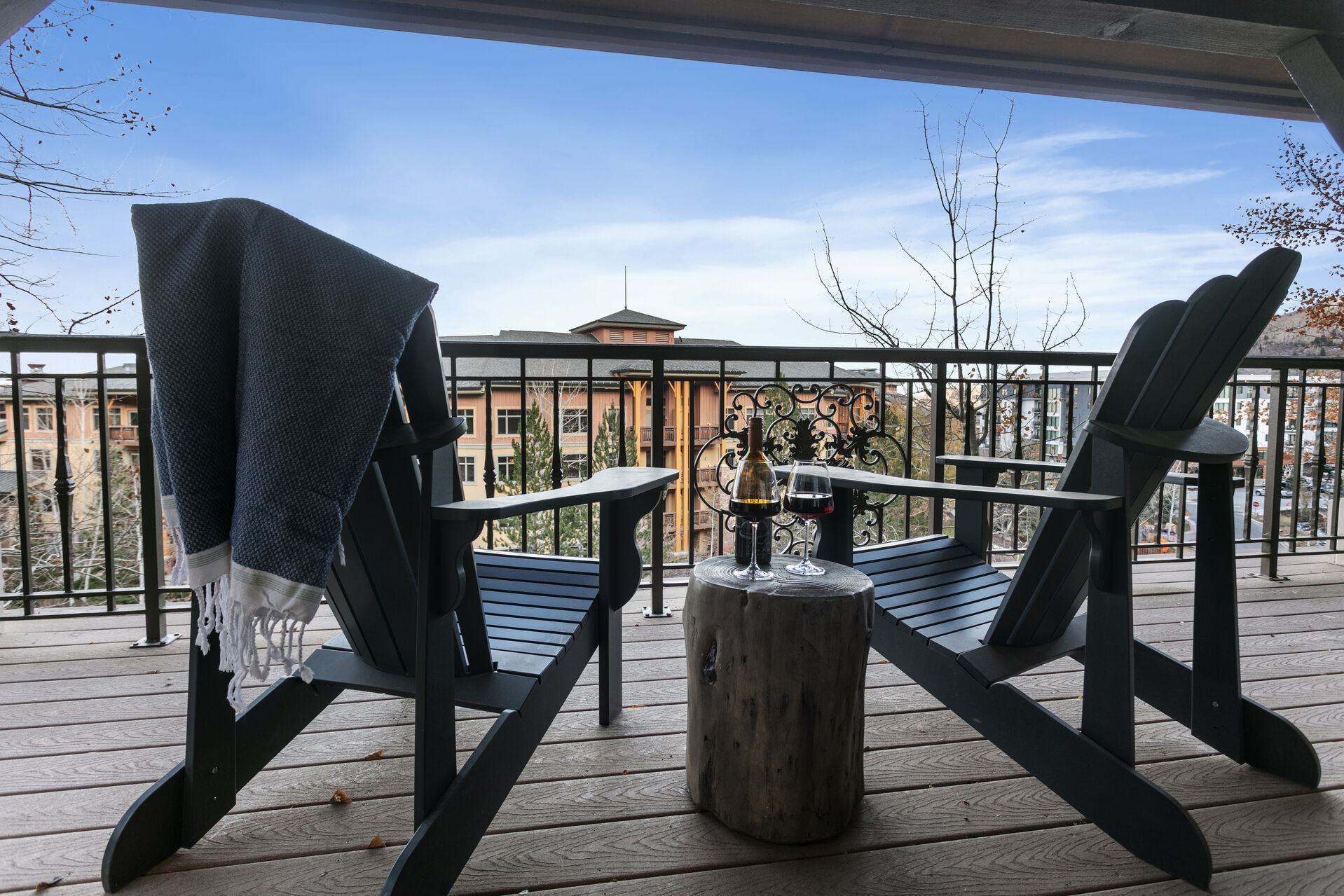 Private patio with chairs to overlook the Canyons Village w/ Traeger smoker on the deck.