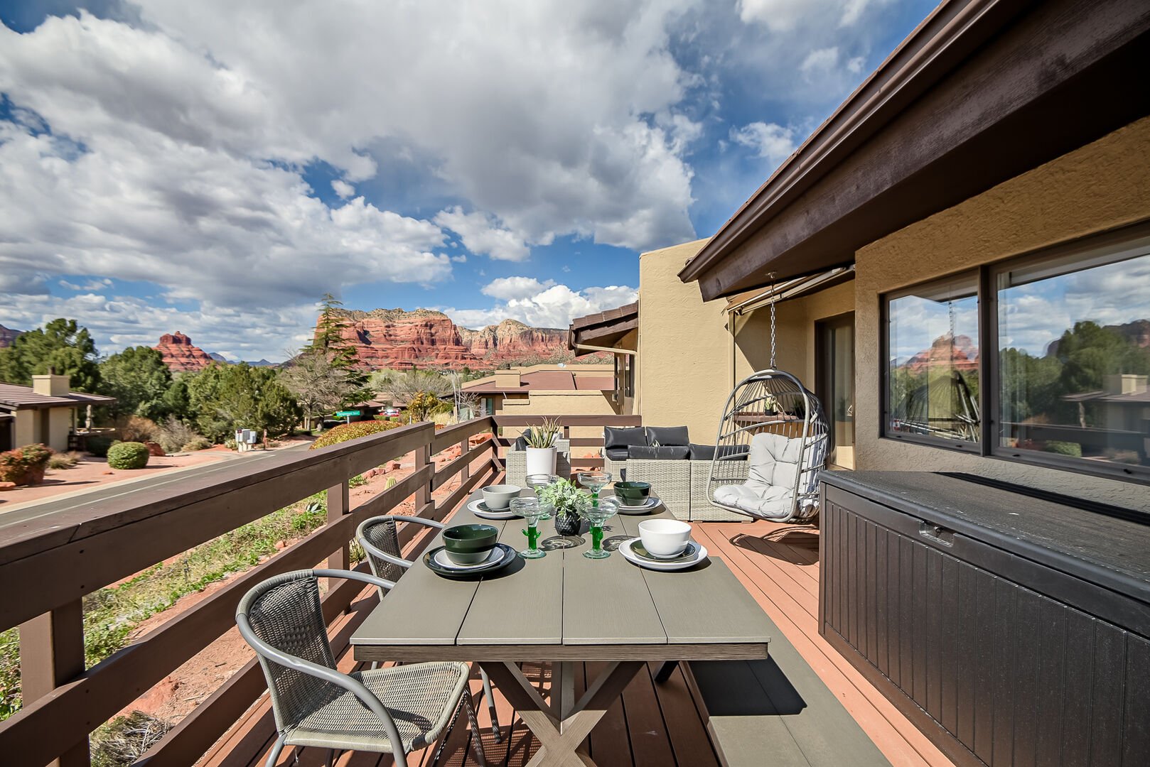 Outdoor patio with seating, outdoor dining, and BBQ grill with red rock views