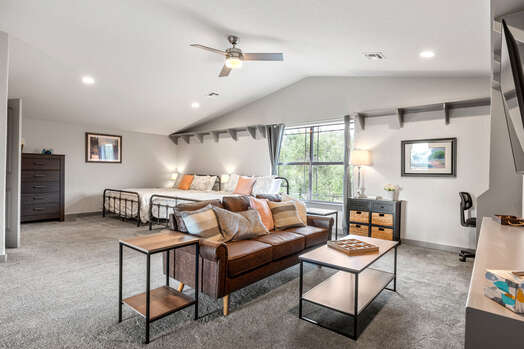 Upper Level Bedroom with 2 Queen Size Beds, Desk, and A Seating Area