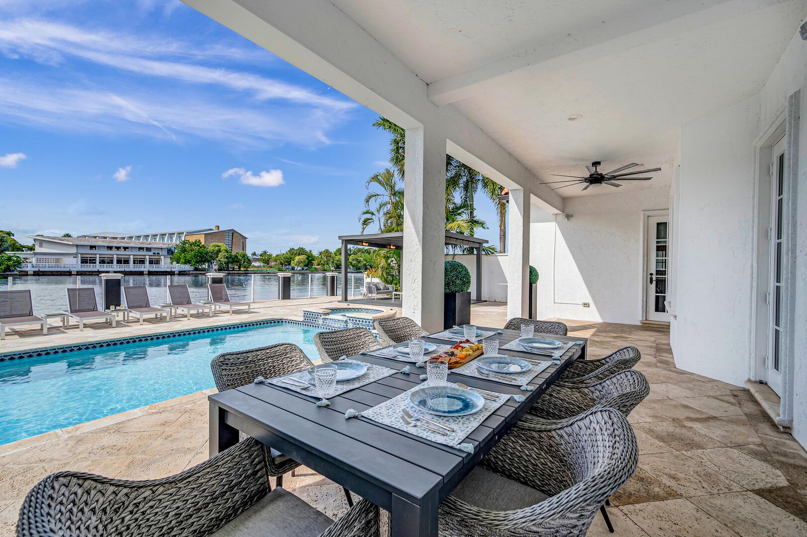 Relish in the waterfront tranquility with canal views from the heated pool, secluded outdoor lounge area by the private dock.