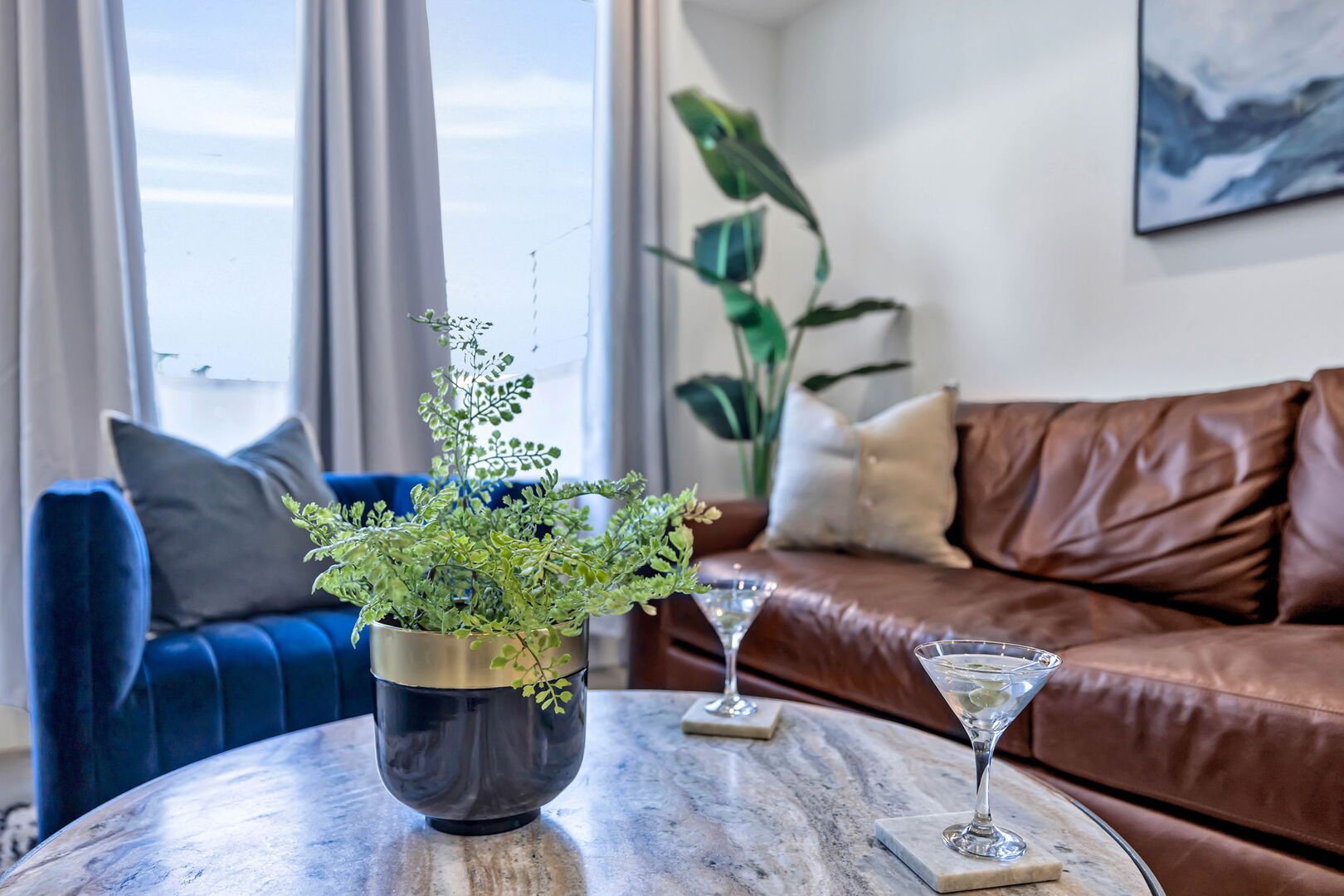 Open-concept living space featuring a comfortable sectional with a Smart TV for entertainment and a fully equipped kitchen stocked with all culinary essentials and stainless steel appliances.