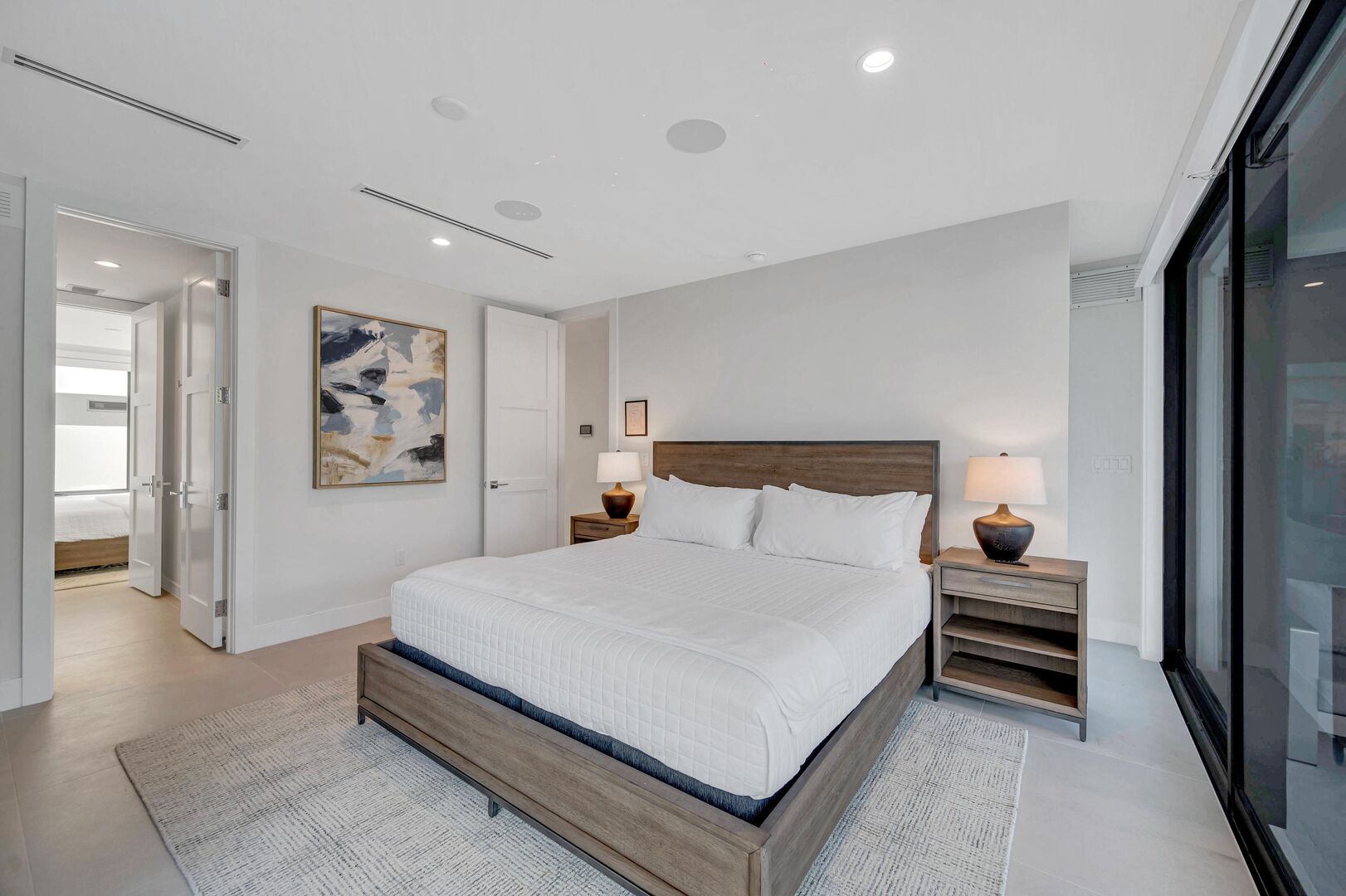 Bedroom Five is located on the first floor with direct pool access and a wet bar. The bedroom features a king size bed, a jack-and-jill bathroom with bedroom five.