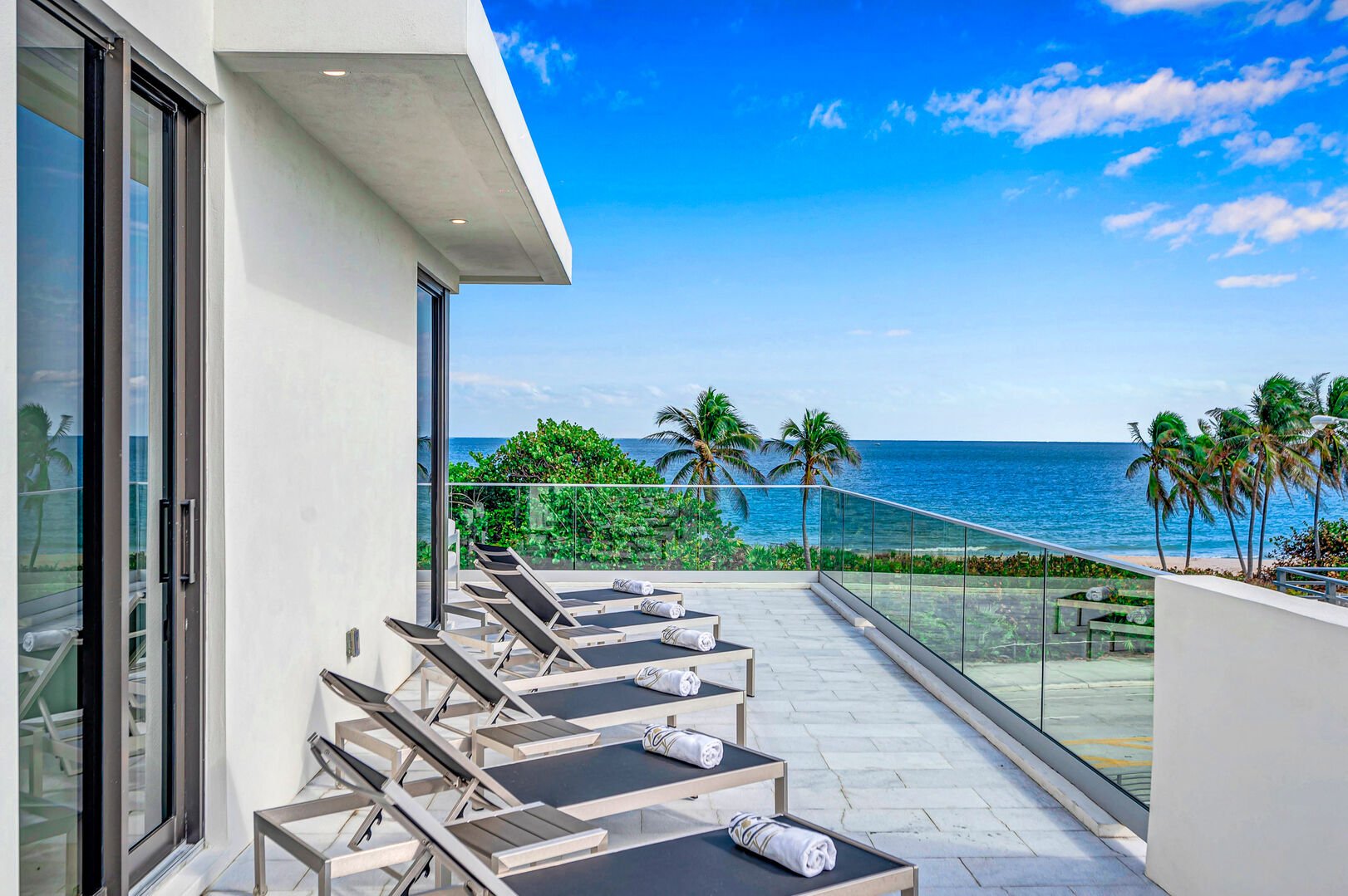 The top terrace with its loungers and a covered patio boast endless Ocean Views by the Fort Lauderdale Beach.