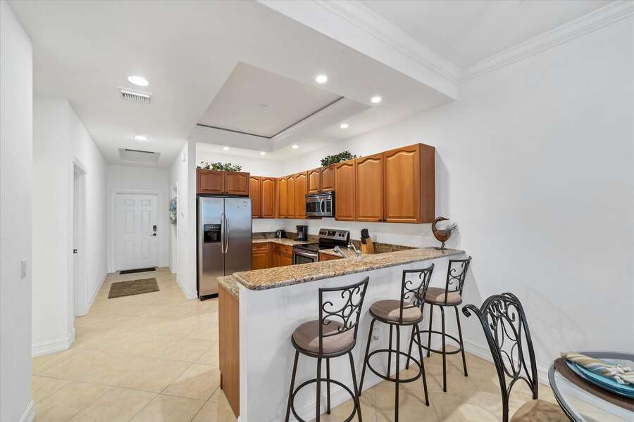 Bright, open, fully-equipped kitchen. Kitchen island seats 3