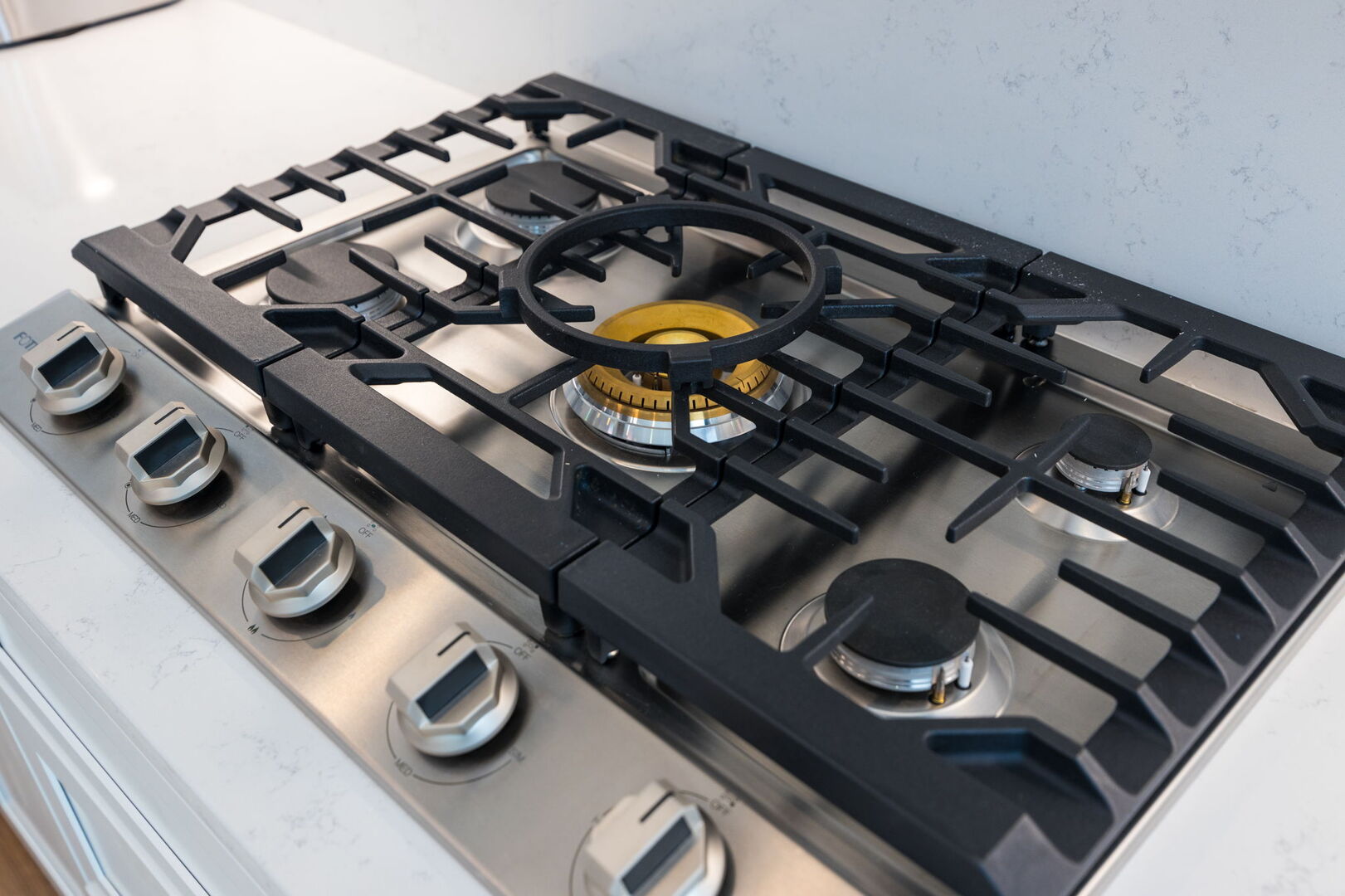 (1st Floor) Fully-equipped kitchen with stainless steel appliances, basic cooking essentials, and kitchen island seating.
