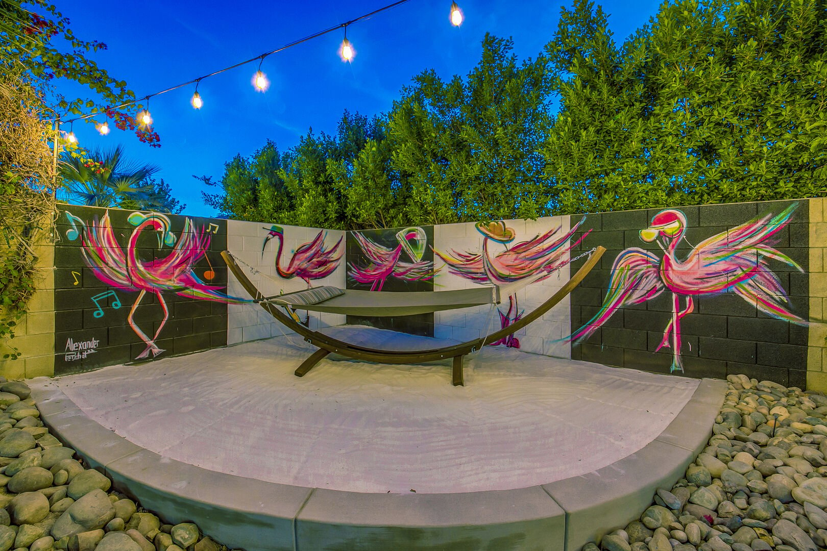 Unwind on the hammock and enjoy the view by the stunning hand painted flamingo artwork!