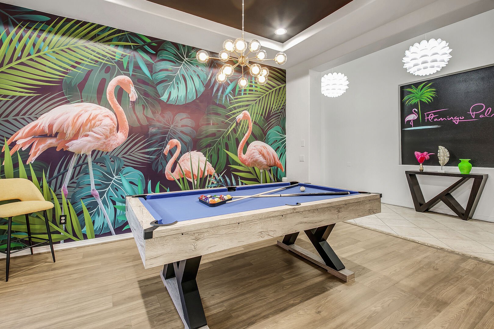 The game room features a pleasing tropical wallpaper mural perfect for your vacation getaway.