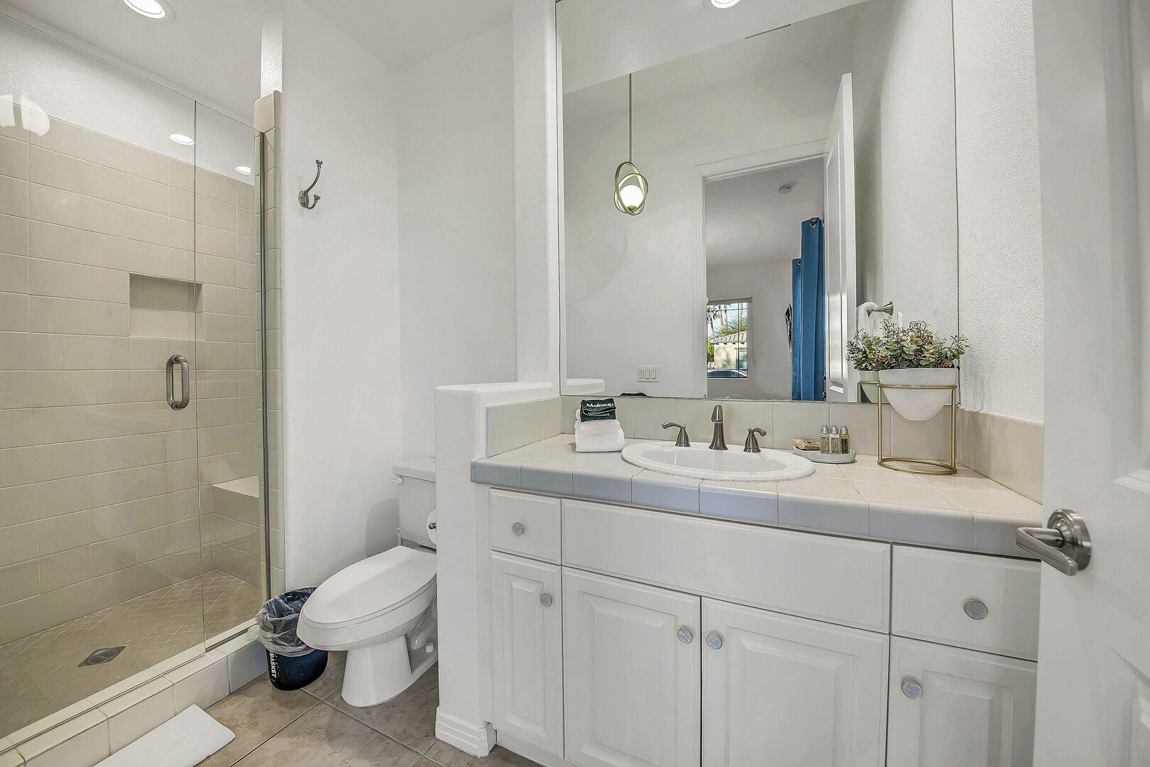 The private casita en suite bathroom features a tile shower and a vanity sink.