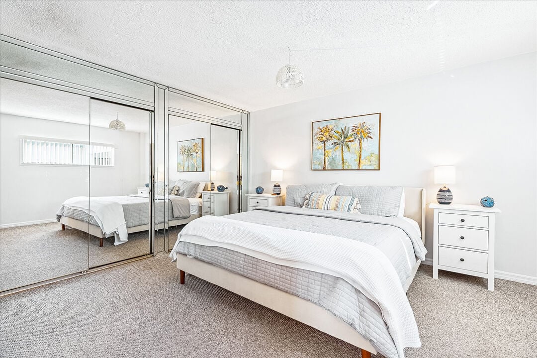 Cozy master bedroom with a plush king bed and plenty of natural light