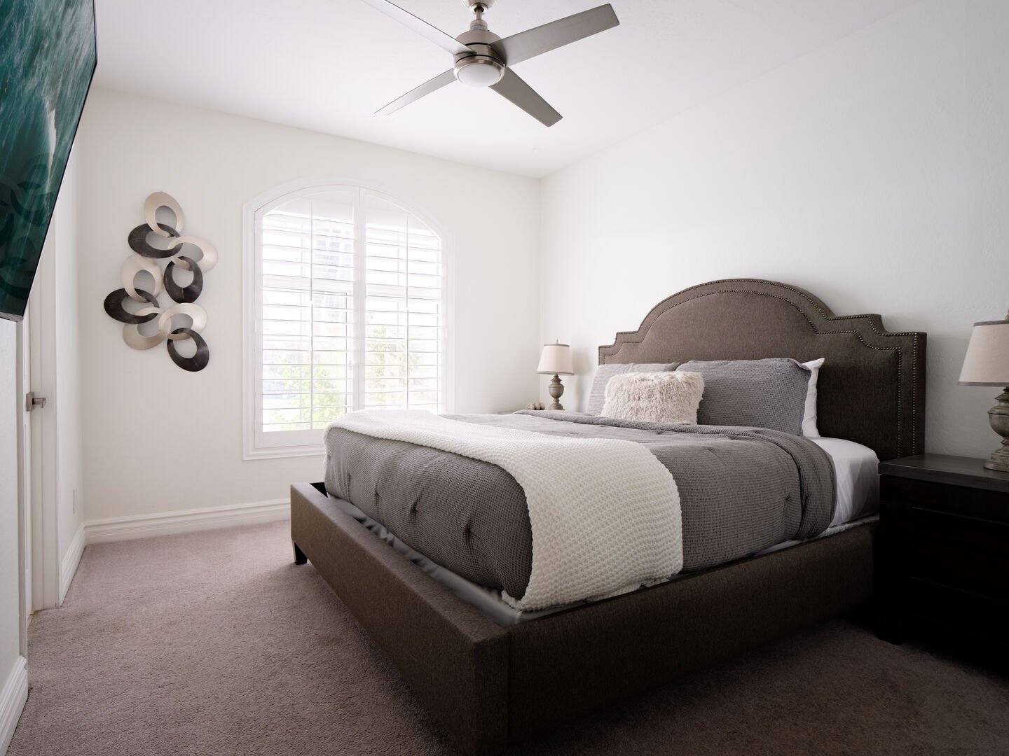 2nd bedroom with King sized bed, smart TV, and Jack and Jill styled bathroom shared with 3rd bedroom
