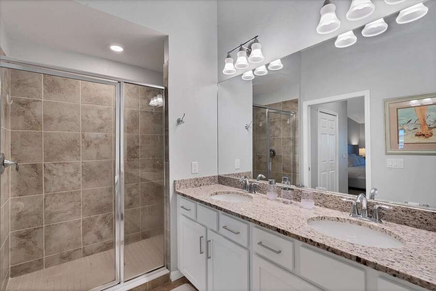 Primary bathroom with double vanity and walk-in shower