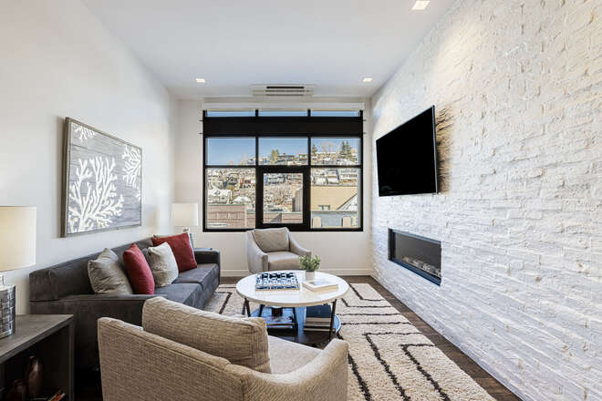 Living Room with a Gas Fireplace, Smart TV, and a View of Main Street
