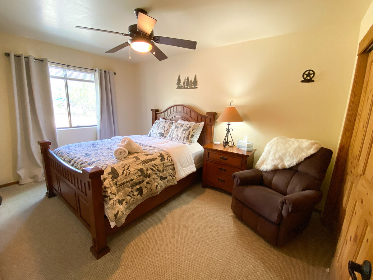First bedroom includes comfy queen bed and reclining reading chair