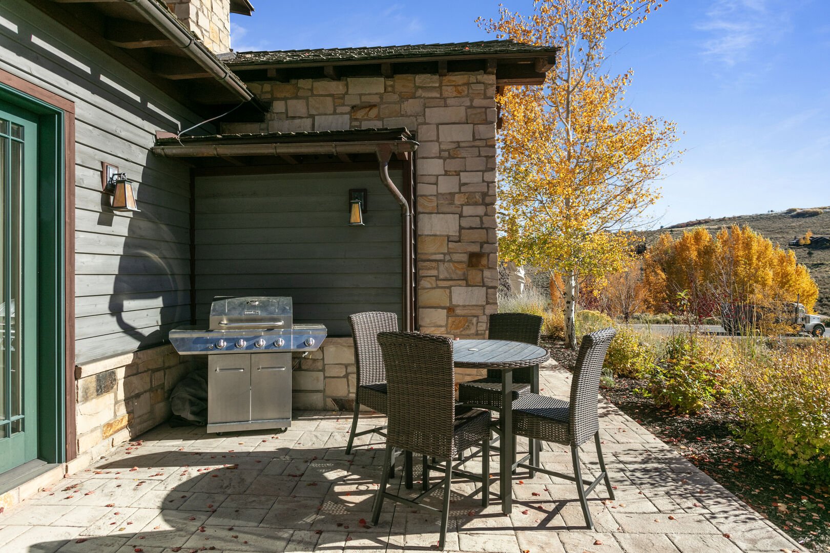 Outdoor dining for up to four and BBQ grill.