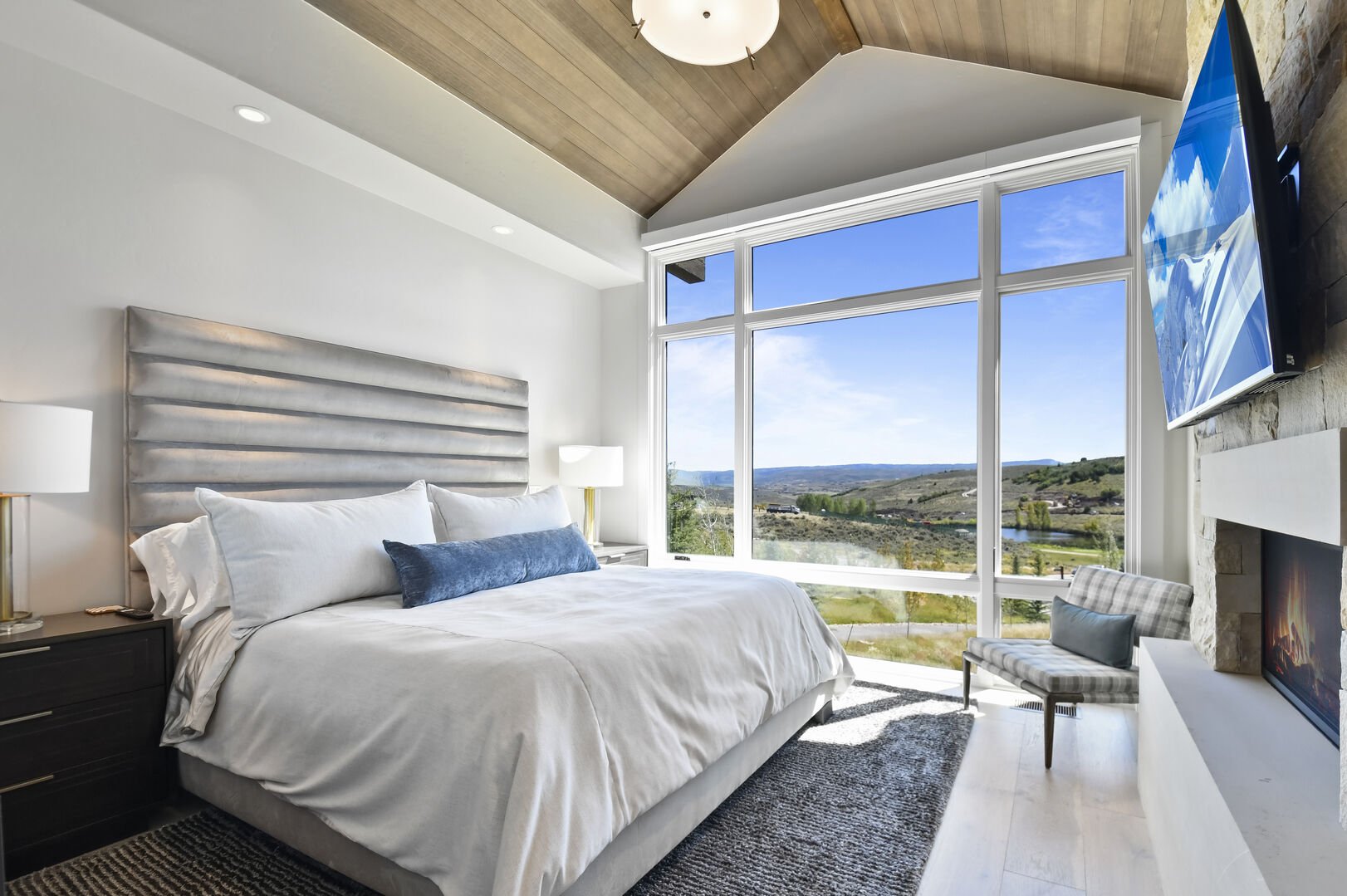 Master bedroom with floor-to-ceiling windows.