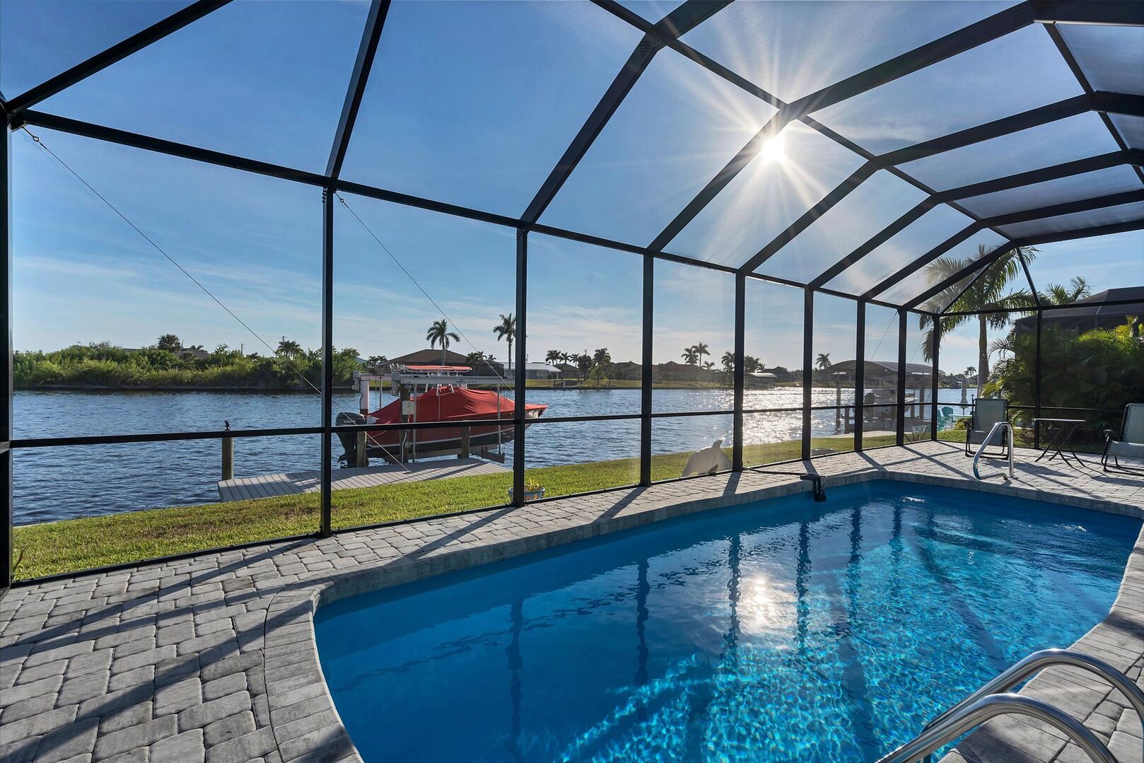 Lovely South Gulf home with sparling pool overlooking canal