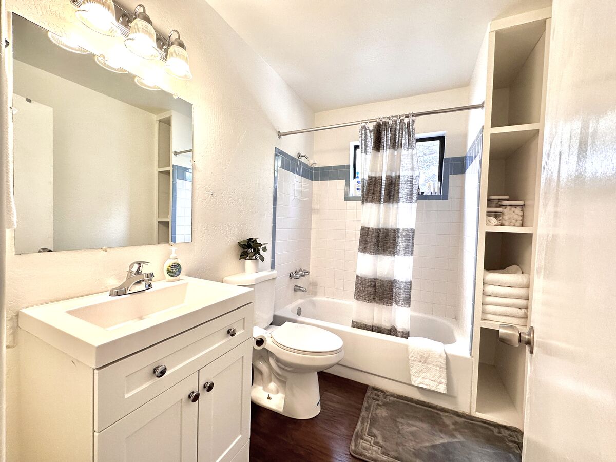 Main level bathroom includes tub/shower combo, and bright lighting. Toiletries included!