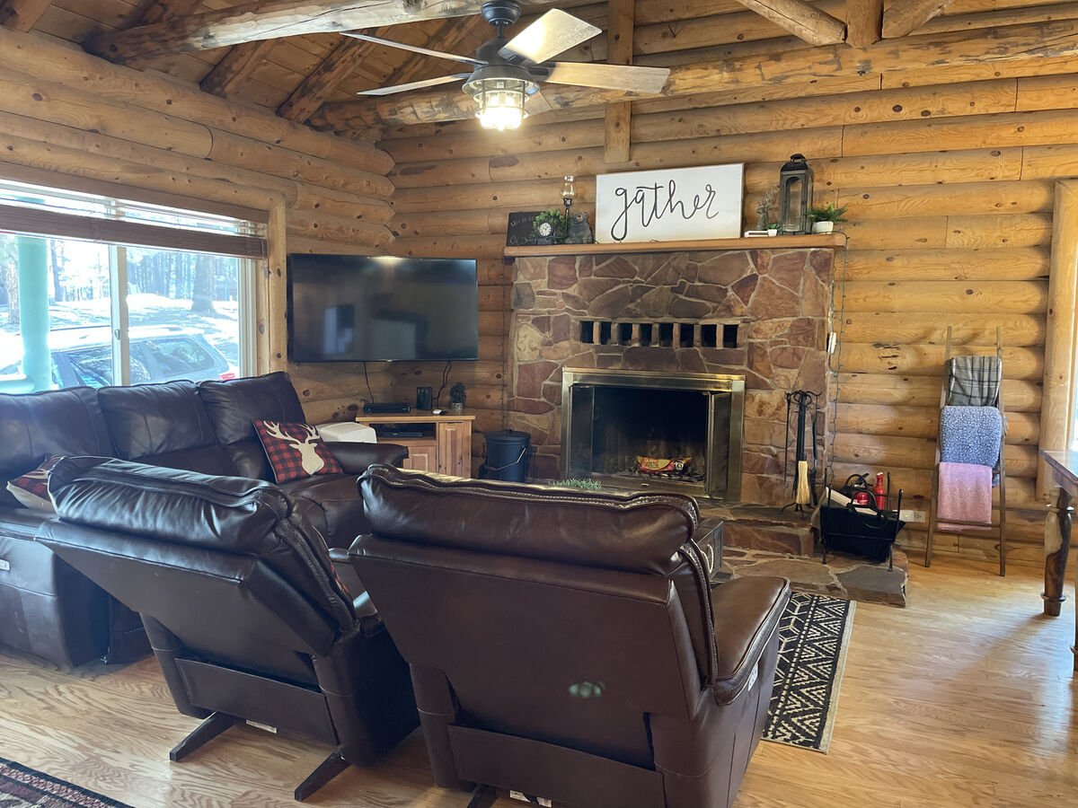Comfy leather seating and wood burning fireplace invite you in