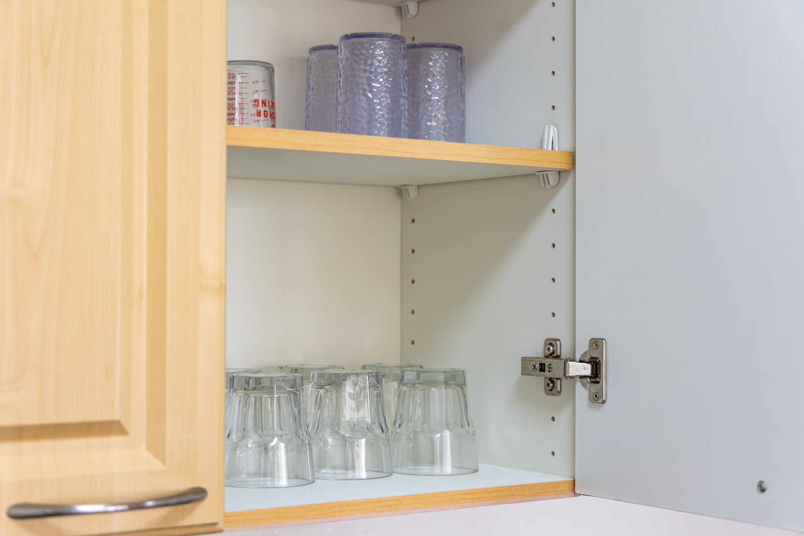 Glasses are also in the cabinet.
